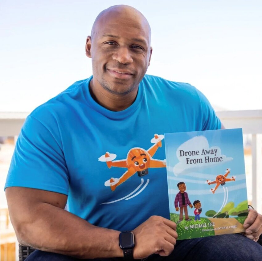 First-time author, Michael Lee sits with his published book, “Drone Away From Home” a children’s book about overcoming obstacles, building friendships and going on adventures.
